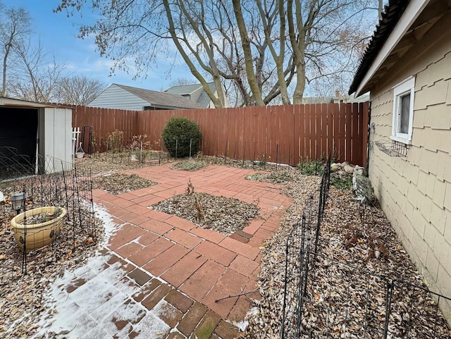 view of patio featuring a storage shed