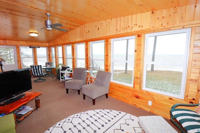 sunroom with ceiling fan, a water view, wood ceiling, and vaulted ceiling