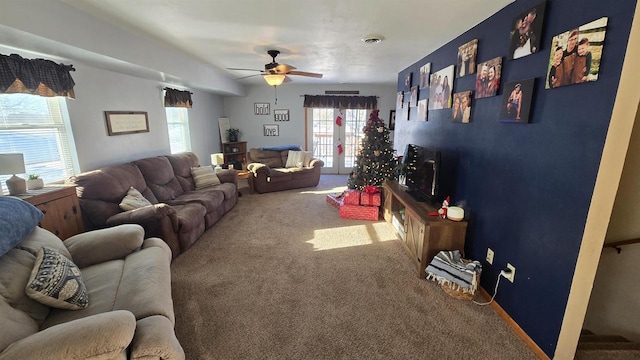 living room featuring ceiling fan and carpet