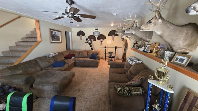 carpeted living room with ceiling fan and a textured ceiling