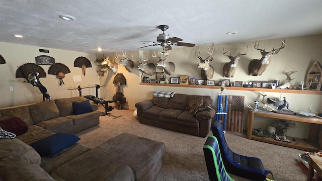 living room with carpet flooring, a textured ceiling, and ceiling fan