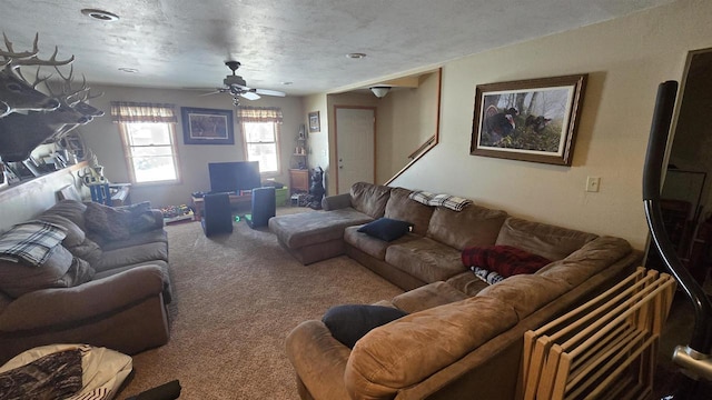 living room with carpet, a textured ceiling, and ceiling fan