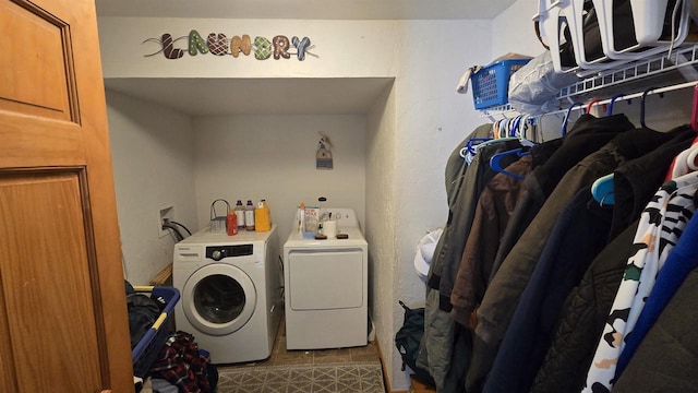 washroom featuring tile patterned floors and separate washer and dryer