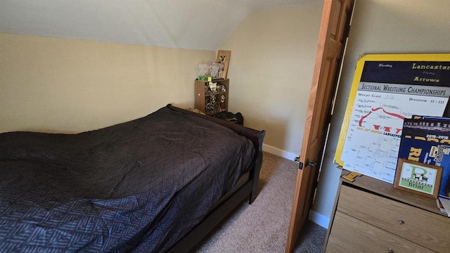 bedroom featuring vaulted ceiling and dark colored carpet