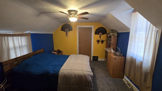 bedroom with ceiling fan, vaulted ceiling, and dark colored carpet