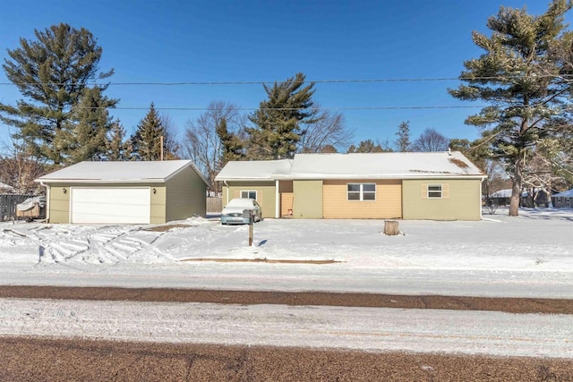 ranch-style home with a garage and an outbuilding