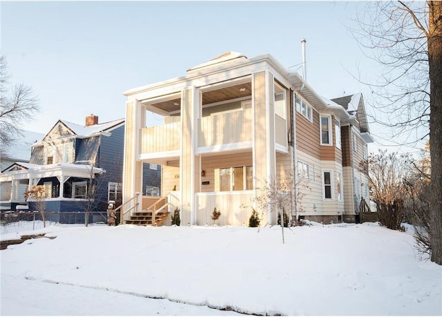 snow covered house with a balcony