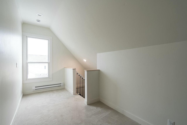 bonus room with light carpet, baseboard heating, and lofted ceiling