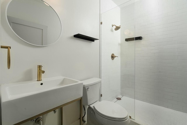 bathroom featuring sink, an enclosed shower, and toilet