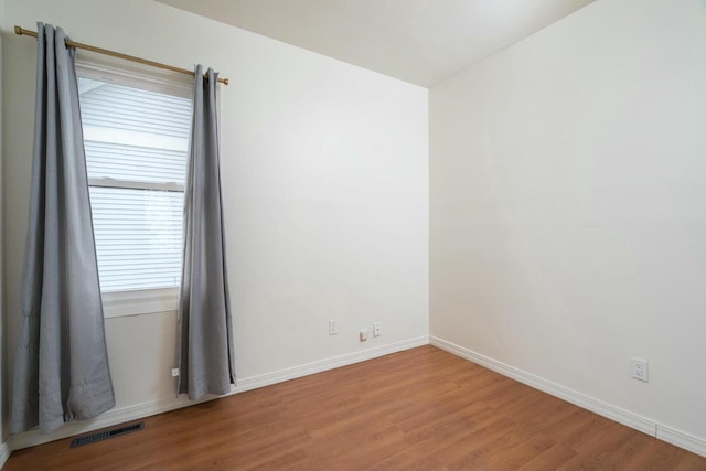 unfurnished room featuring wood-type flooring