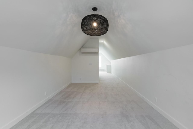 additional living space with an AC wall unit, light colored carpet, and lofted ceiling