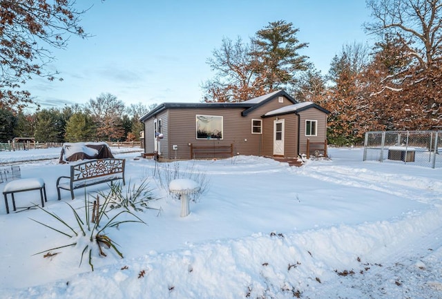 view of snow covered rear of property