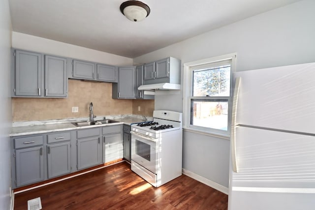 kitchen with dark hardwood / wood-style flooring, white appliances, gray cabinetry, and sink