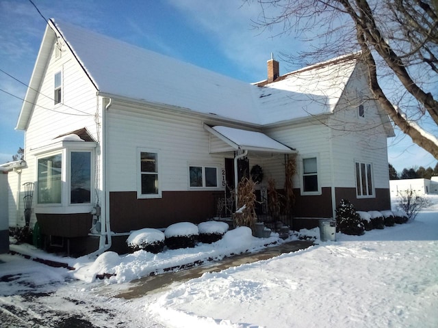 view of front facade featuring a chimney