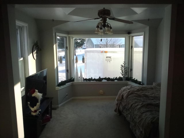 carpeted bedroom featuring baseboards and a ceiling fan