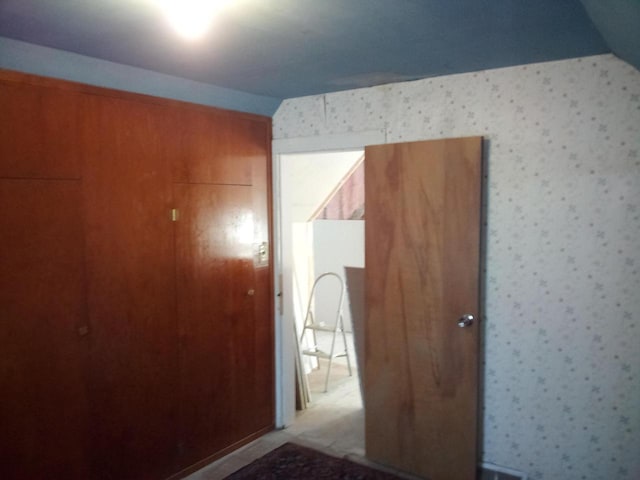 unfurnished bedroom featuring wallpapered walls