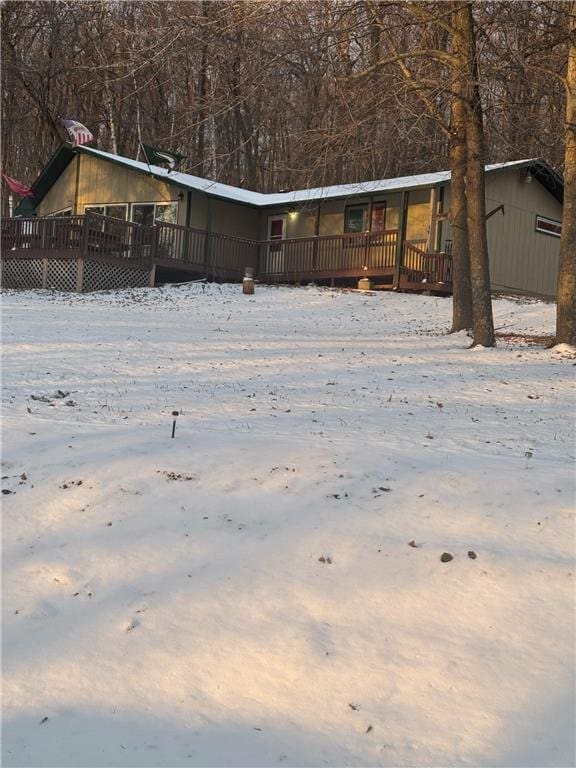 yard covered in snow with a wooden deck