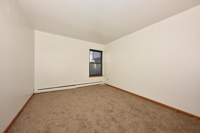 spare room featuring baseboard heating and carpet flooring