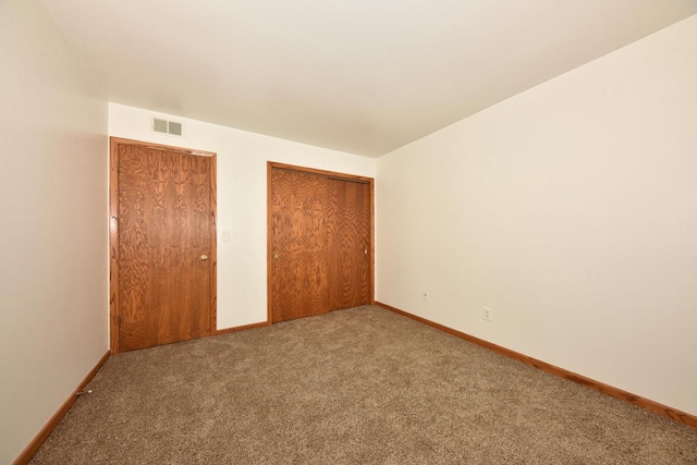 unfurnished bedroom featuring carpet flooring and a closet