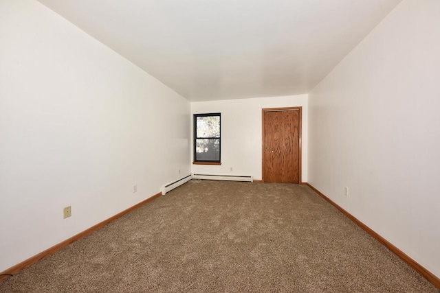 spare room featuring carpet and a baseboard radiator