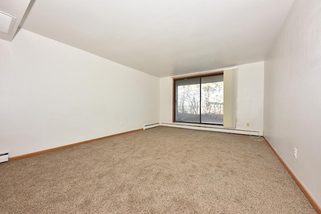 carpeted empty room featuring baseboard heating