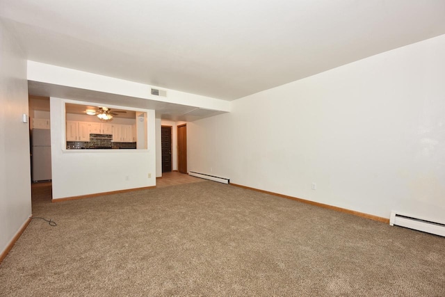 unfurnished living room featuring carpet, baseboard heating, and ceiling fan