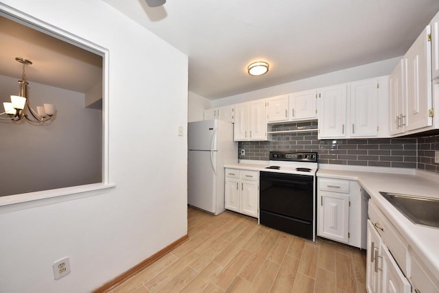 kitchen featuring white appliances, hanging light fixtures, decorative backsplash, a notable chandelier, and white cabinetry