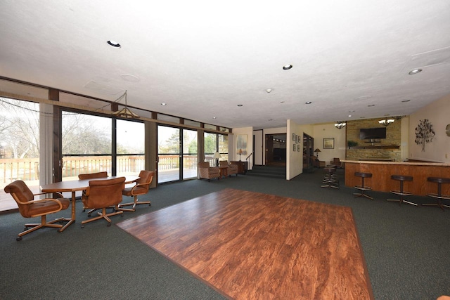 unfurnished living room featuring dark carpet