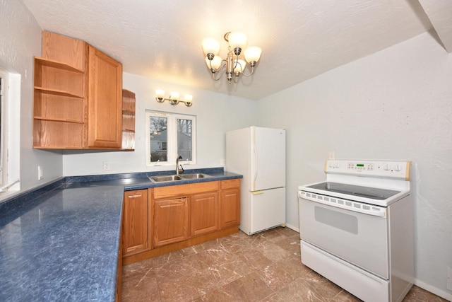 kitchen featuring a textured ceiling, sink, a chandelier, and white appliances