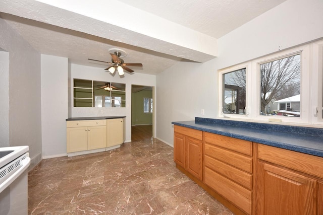 kitchen with a textured ceiling, white range, and ceiling fan