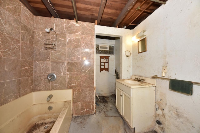 bathroom with vanity, concrete flooring, and a tub