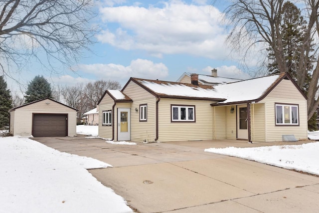 view of front of property with a garage and an outdoor structure