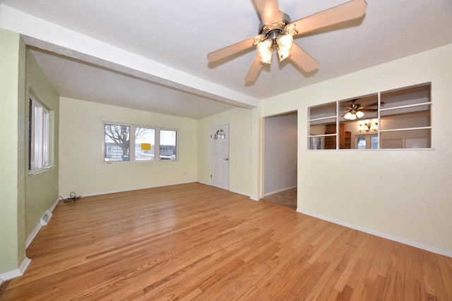 unfurnished room with beam ceiling, ceiling fan, and light hardwood / wood-style flooring