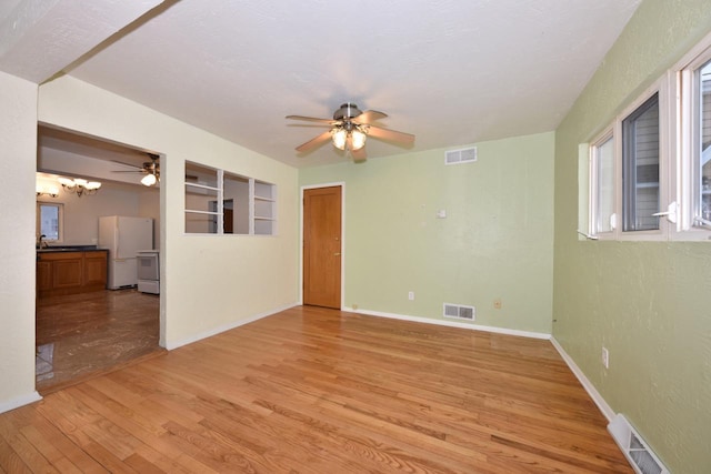 spare room featuring ceiling fan, light hardwood / wood-style floors, and sink