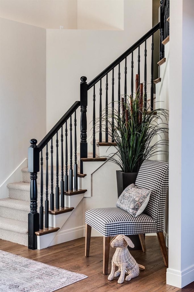 stairs with hardwood / wood-style flooring