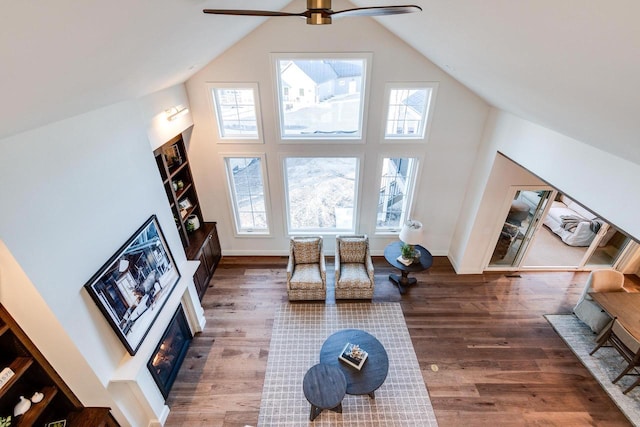 living room featuring plenty of natural light, high vaulted ceiling, dark hardwood / wood-style floors, and ceiling fan