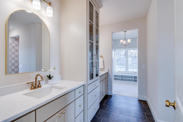 bathroom featuring an inviting chandelier and vanity