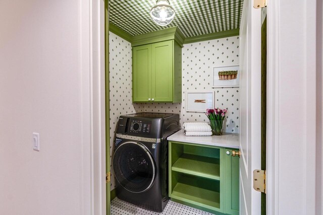 laundry room featuring washer / clothes dryer and cabinets