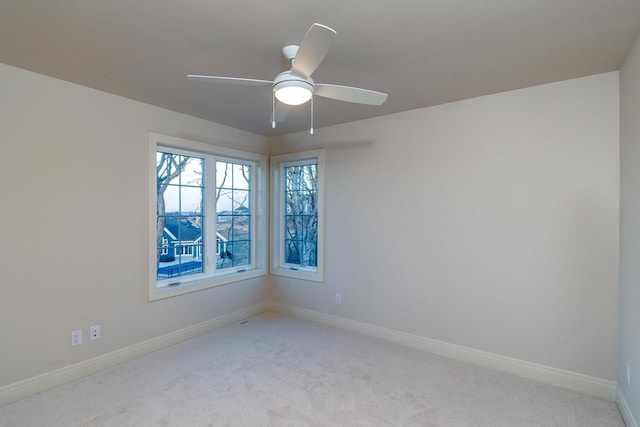 unfurnished room featuring light carpet and ceiling fan