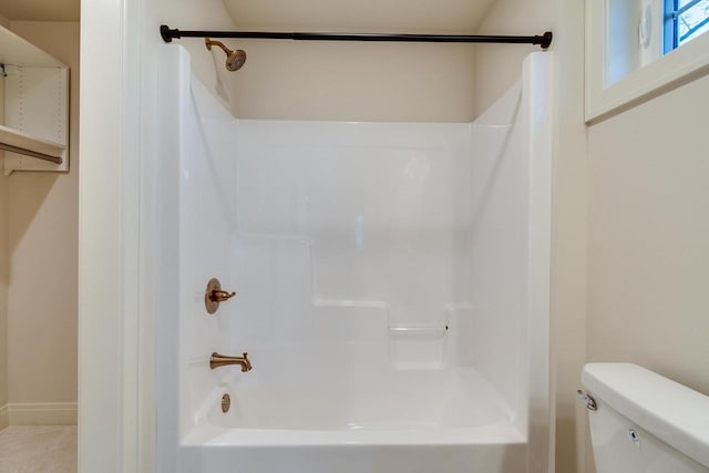 bathroom with shower / washtub combination and toilet