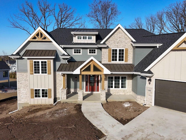 craftsman inspired home featuring a garage and covered porch