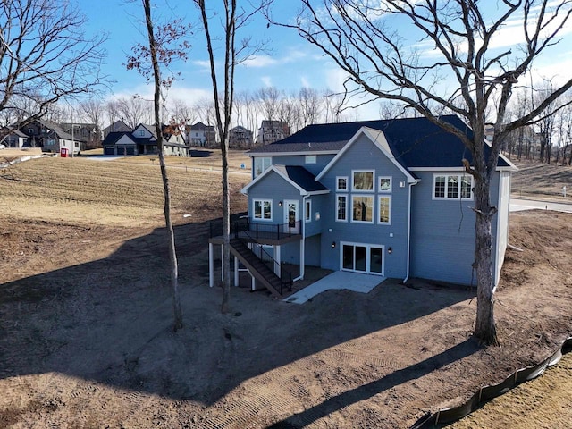 rear view of house featuring a deck