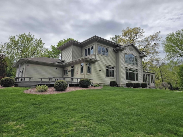 back of house featuring a deck and a yard