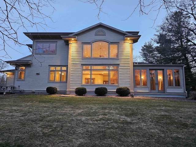 rear view of house featuring a yard