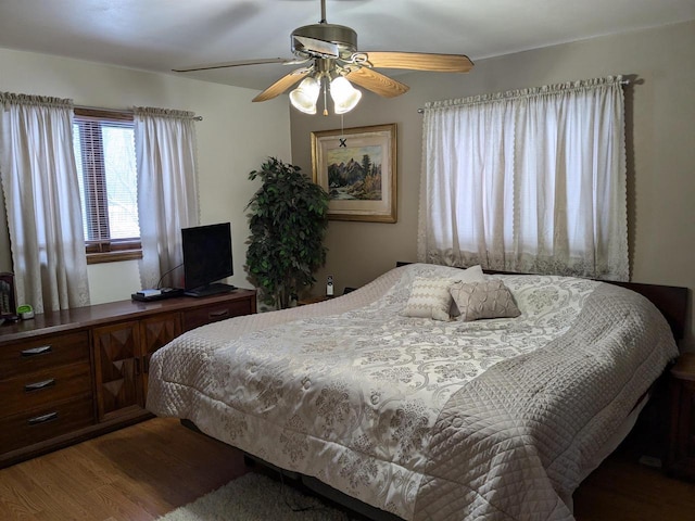 bedroom with hardwood / wood-style flooring and ceiling fan