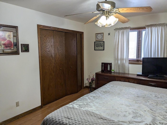 bedroom with ceiling fan, a closet, and hardwood / wood-style flooring