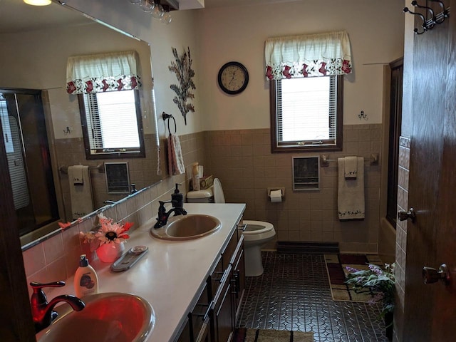 bathroom with vanity, tile walls, and toilet