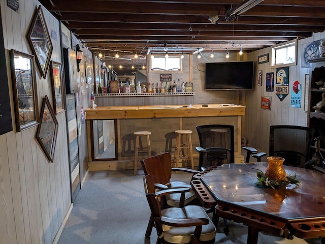 interior space with bar and wood walls