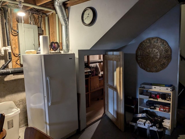 kitchen with electric panel and white refrigerator