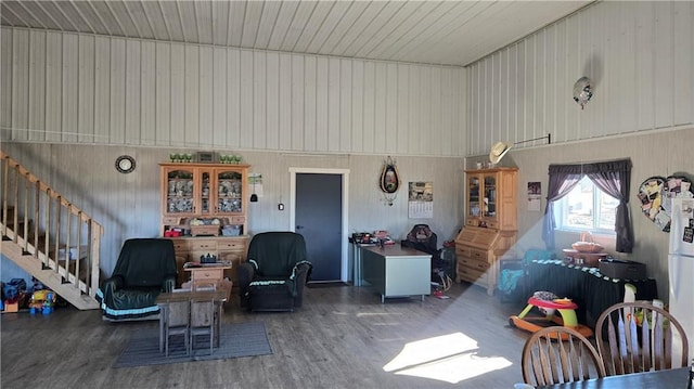 living room featuring wood-type flooring and wooden walls